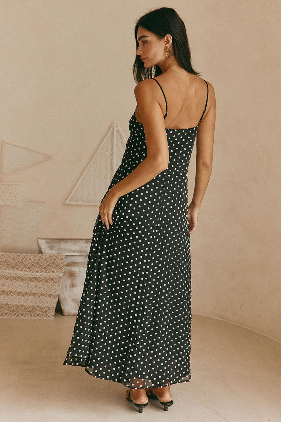 Black maxi dress with a V neckline, styled on model