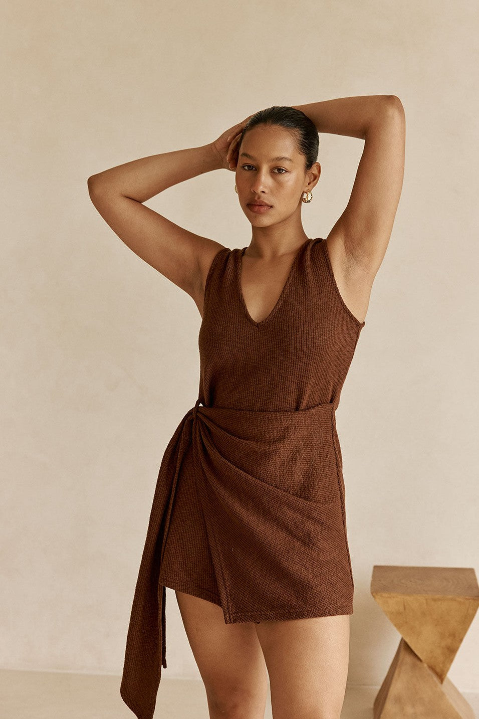 Brown mini dress with a V neckline, styled on model