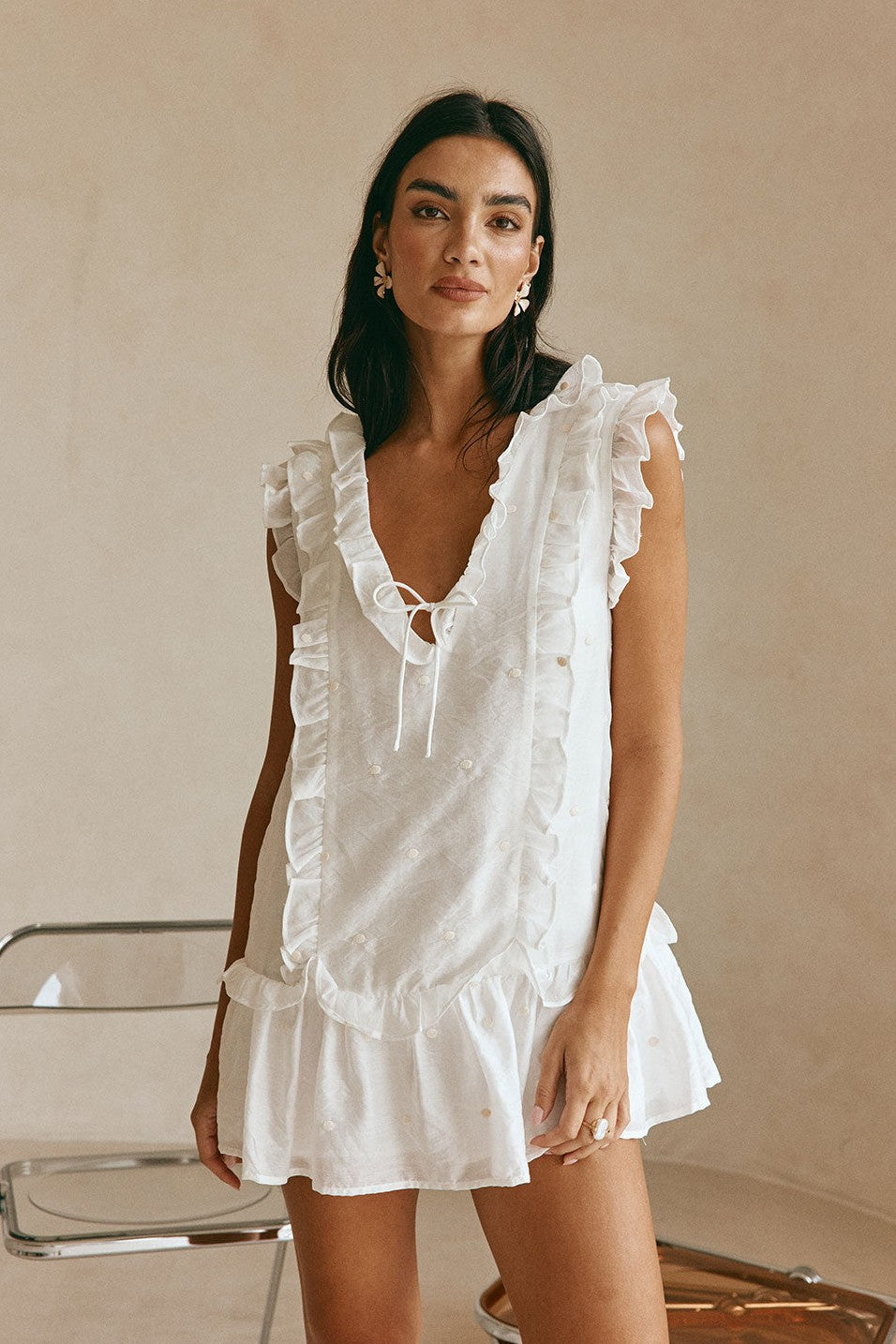White mini dress with a V neckline, side view