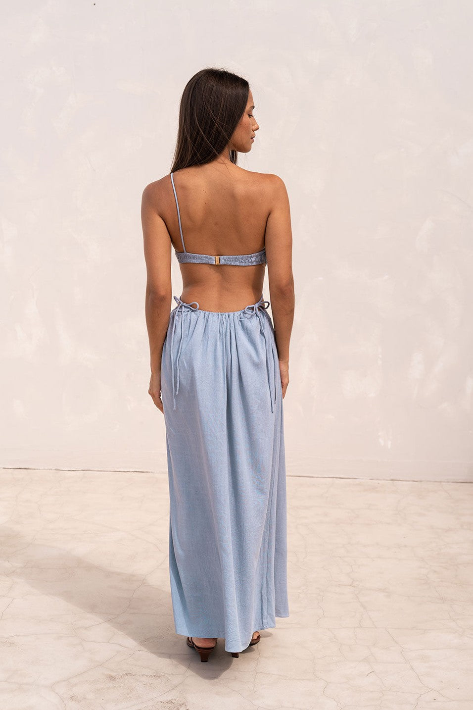 Blue maxi dress with an open back, back view