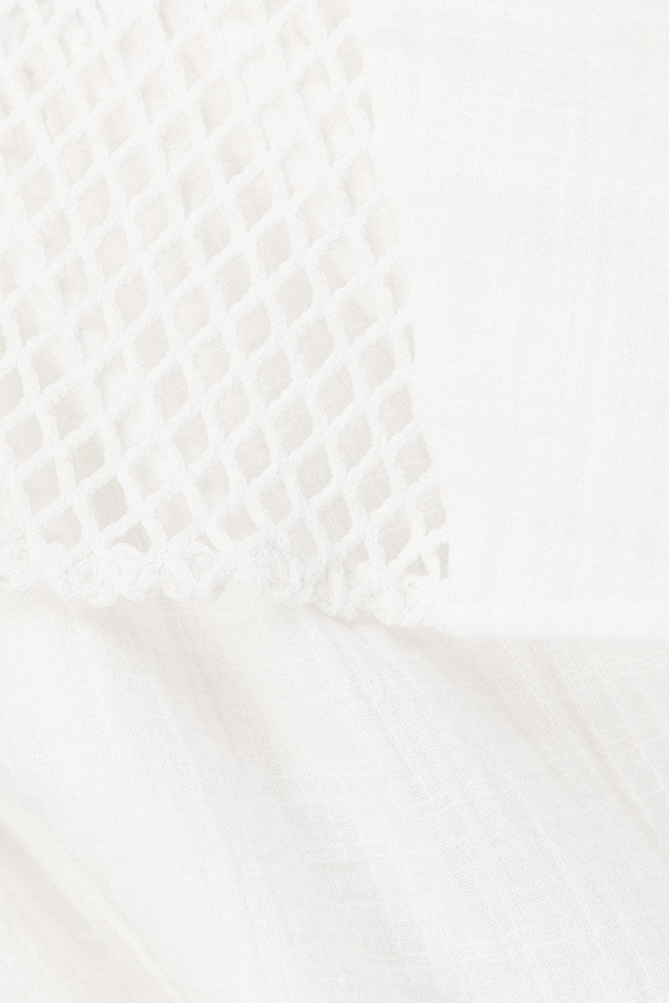 White mini dress with an A-line skirt, detail view