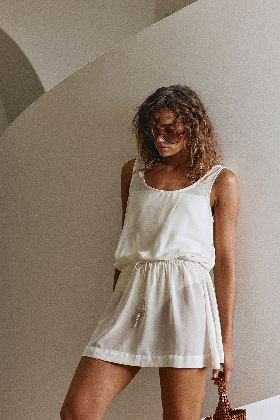 Beige mini dress with a halter neckline, detail view