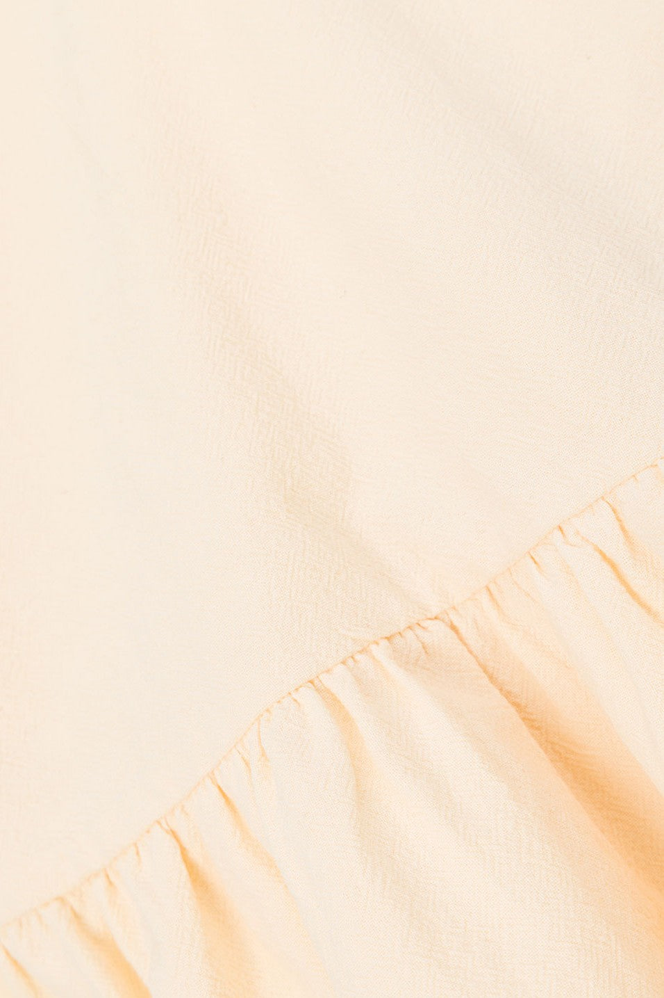 Cream mini dress with a boat neckline, back view