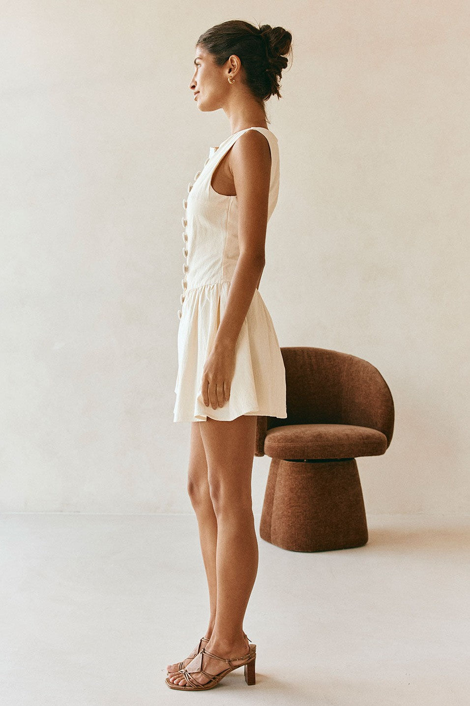 Cream mini dress with a boat neckline, detail view