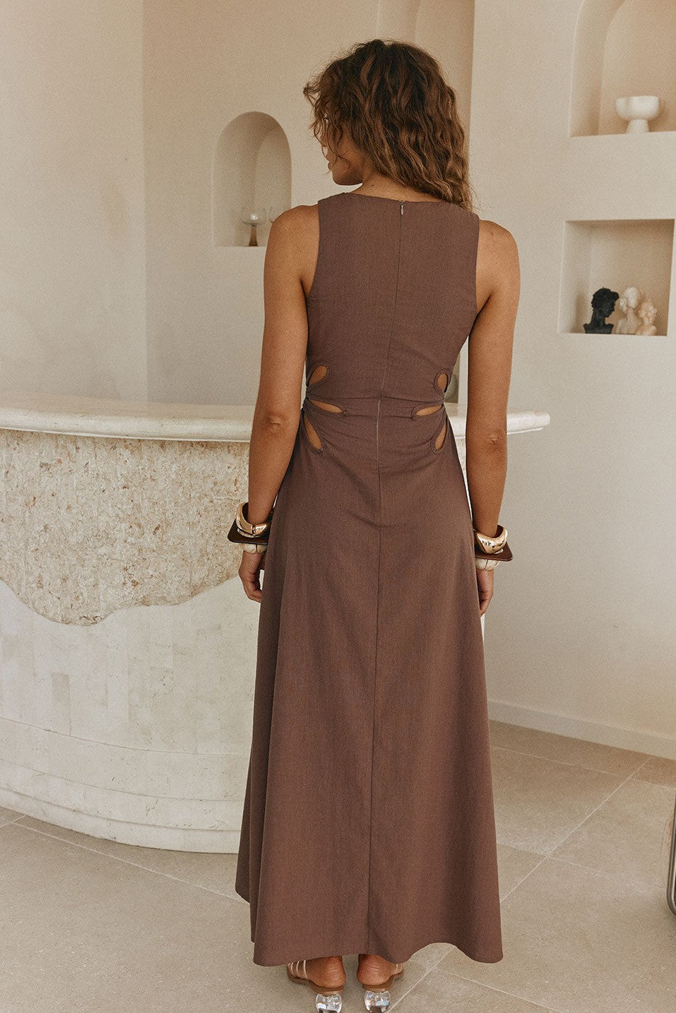 Brown maxi dress with a V neckline, styled on model