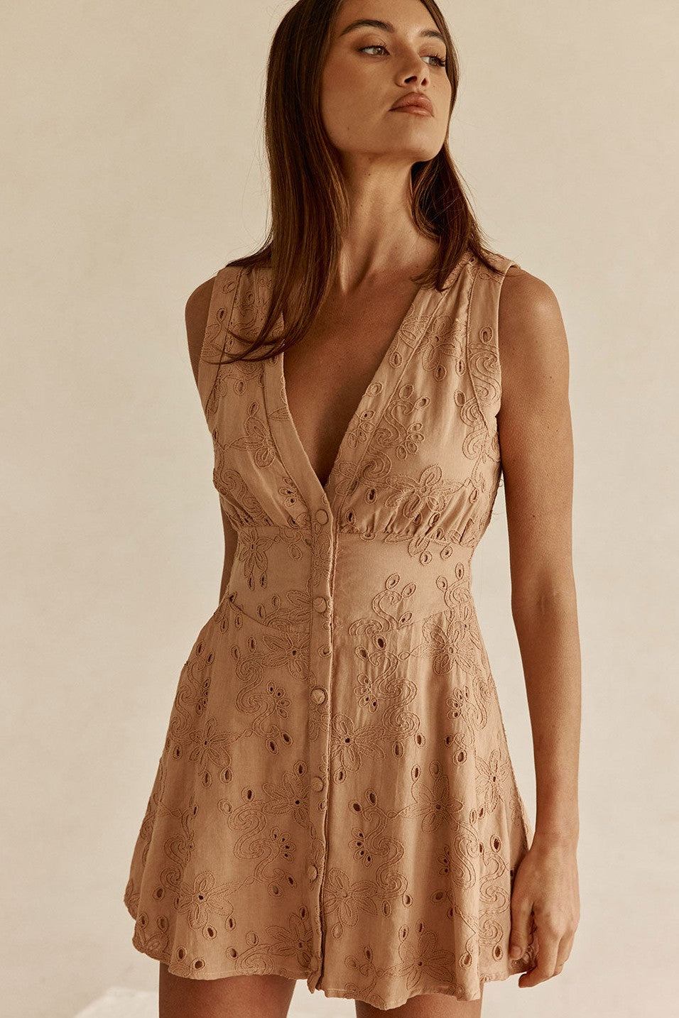 Cream mini dress with a plunging V neckline, side view