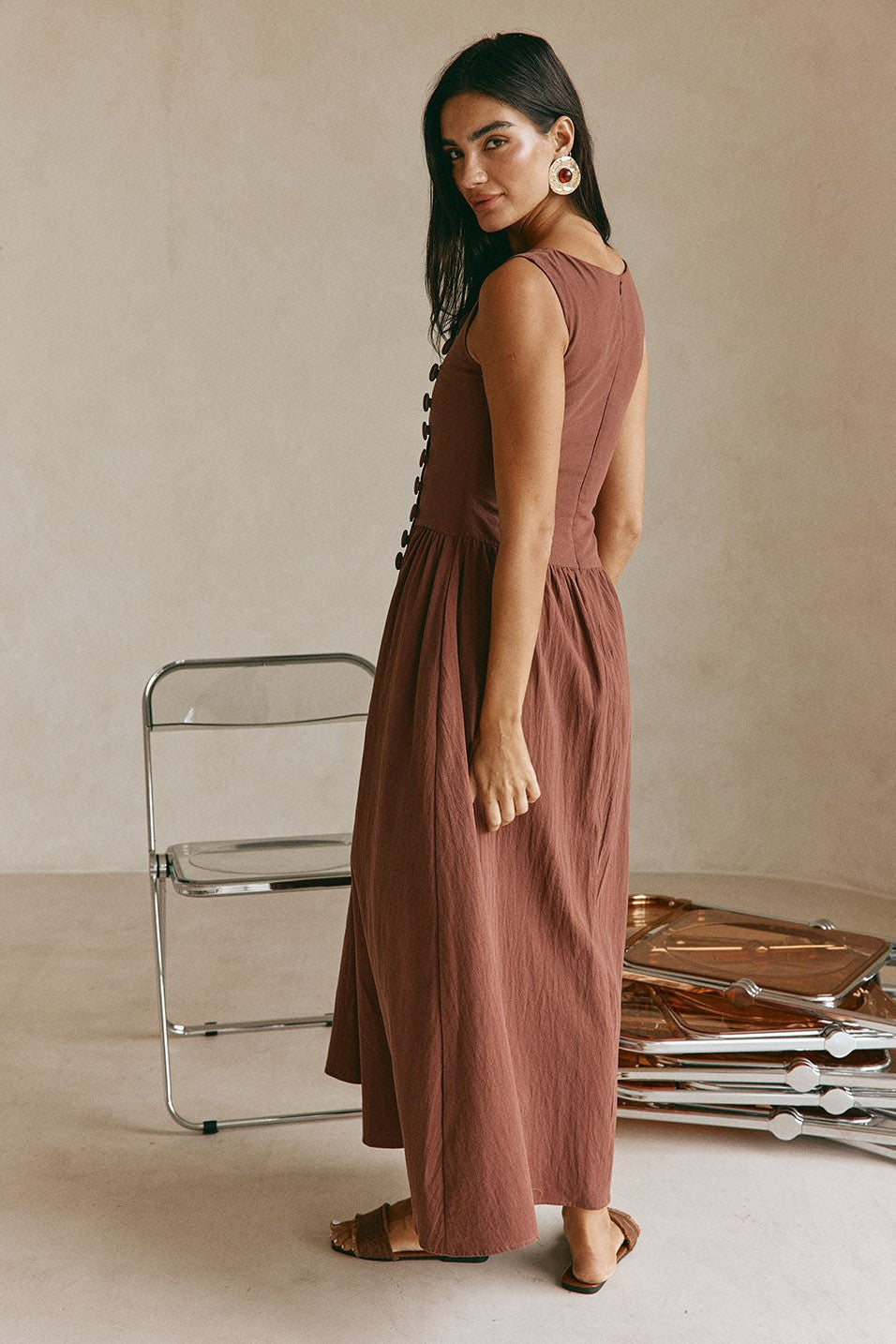 Brown maxi dress with a boat neckline, styled on model