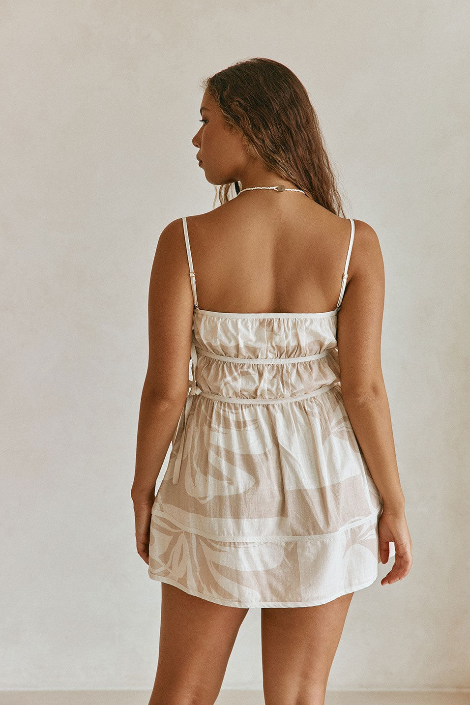 Beige mini dress with a side split, back view