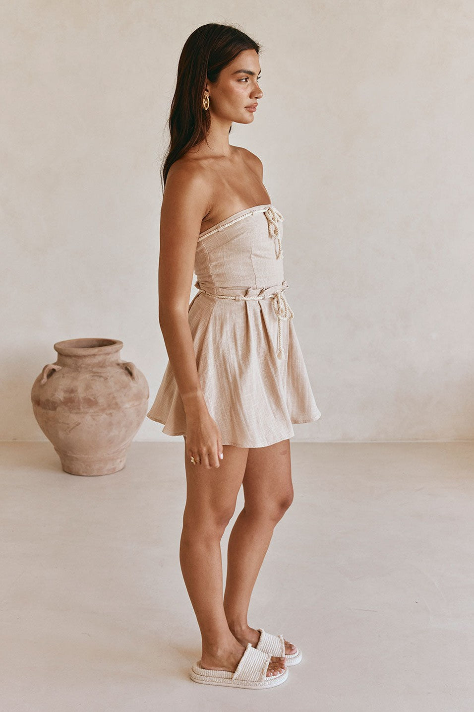 Beige mini dress with a strapless neckline, detail view