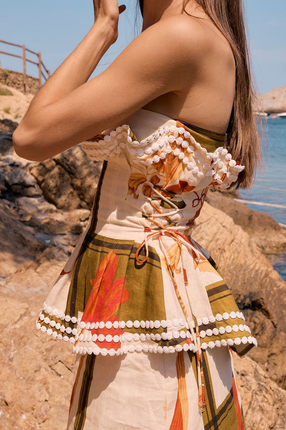 Orange maxi dress with a strapless neckline, detail view