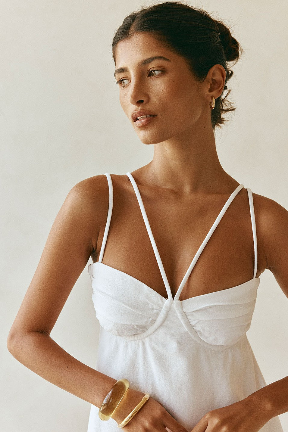 White mini dress with a round neckline, side view