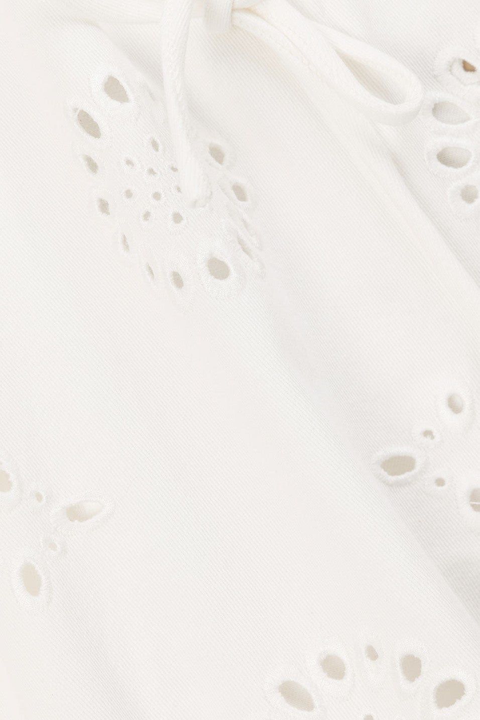 White mini dress with an A-line skirt, side view