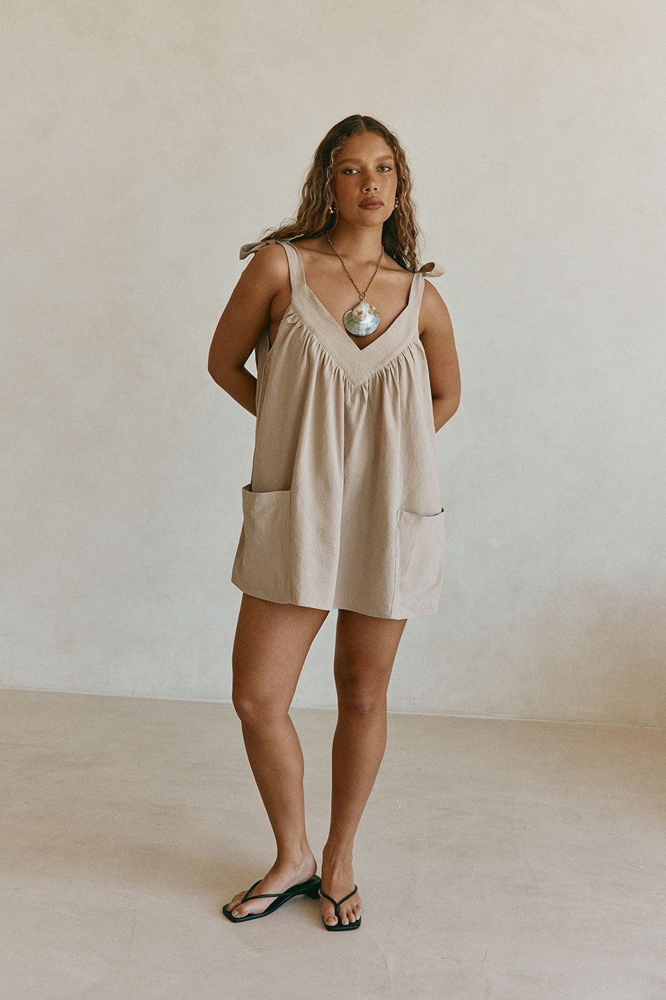 Beige mini dress, styled on model