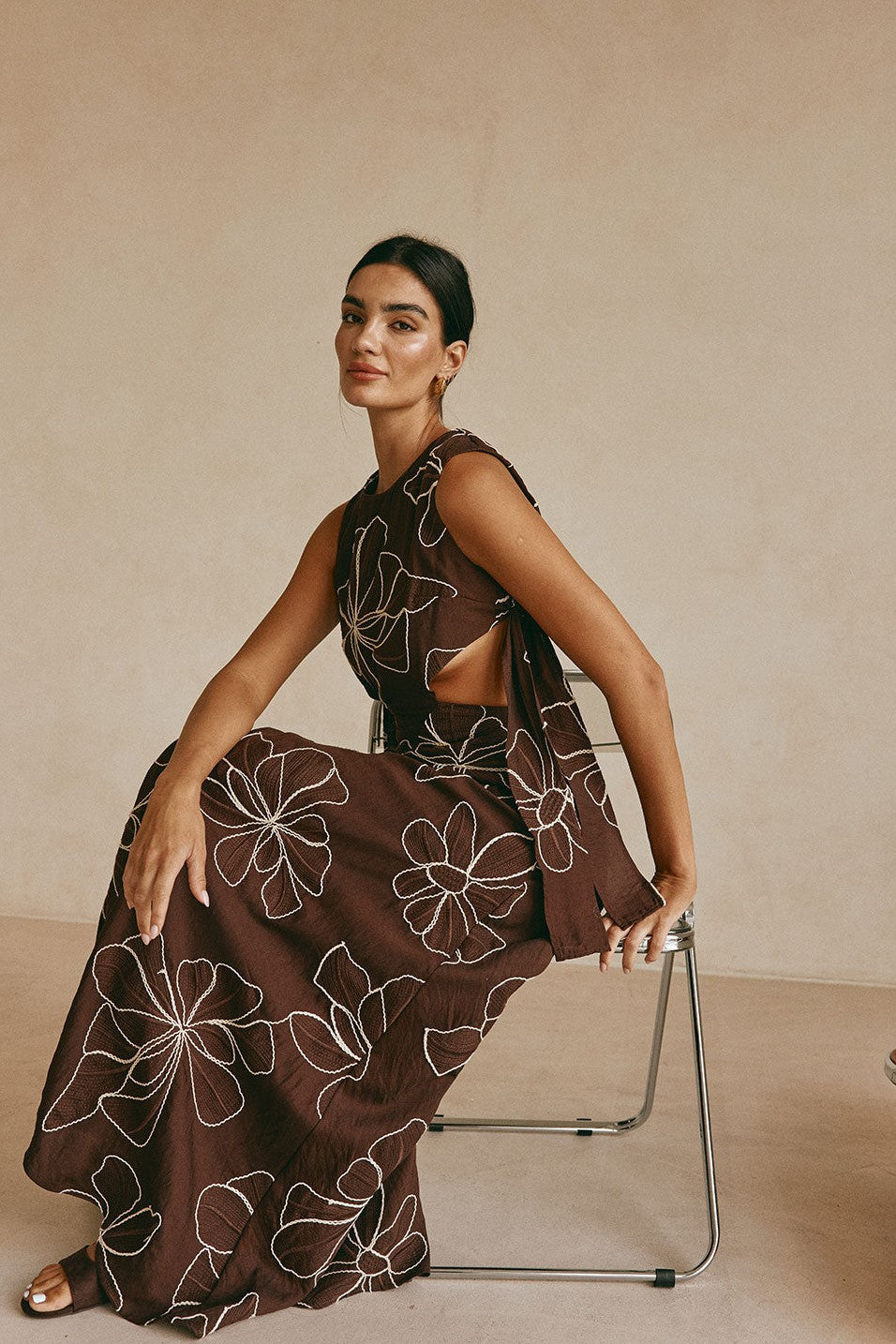 Brown maxi dress with an A-line skirt, side view