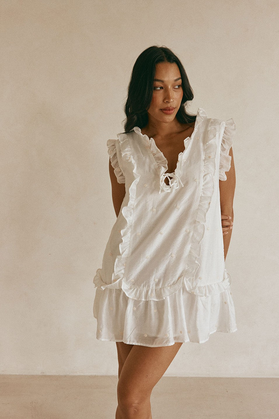White mini dress with a V neckline, back view