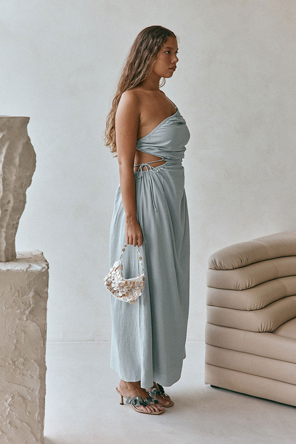 Blue maxi dress with an open back, side view