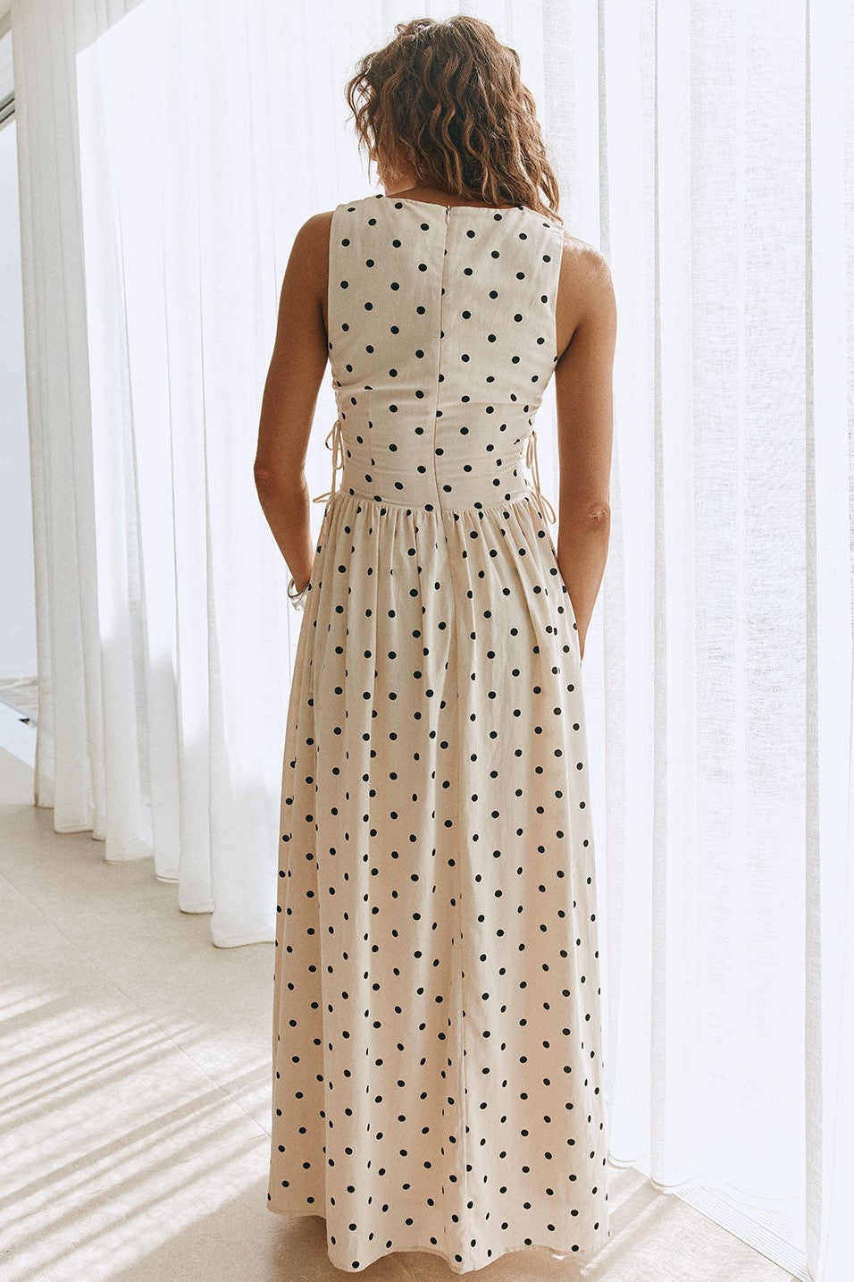 Cream maxi dress with a plunging V neckline, back view