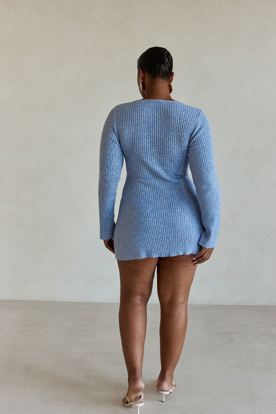 Blue mini dress with a plunging V neckline, side view