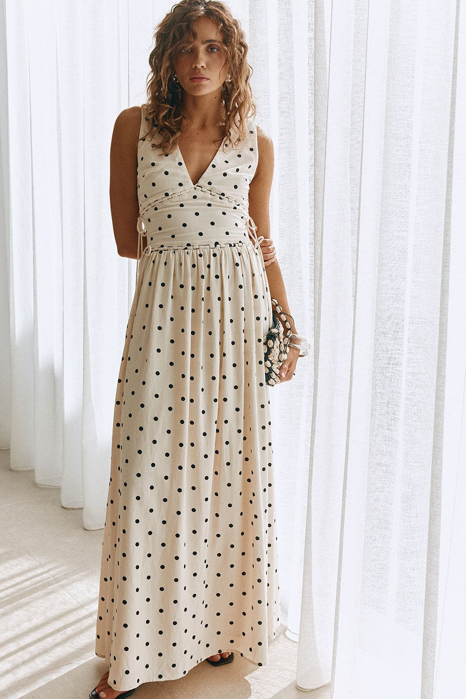 Cream maxi dress with a plunging V neckline, side view