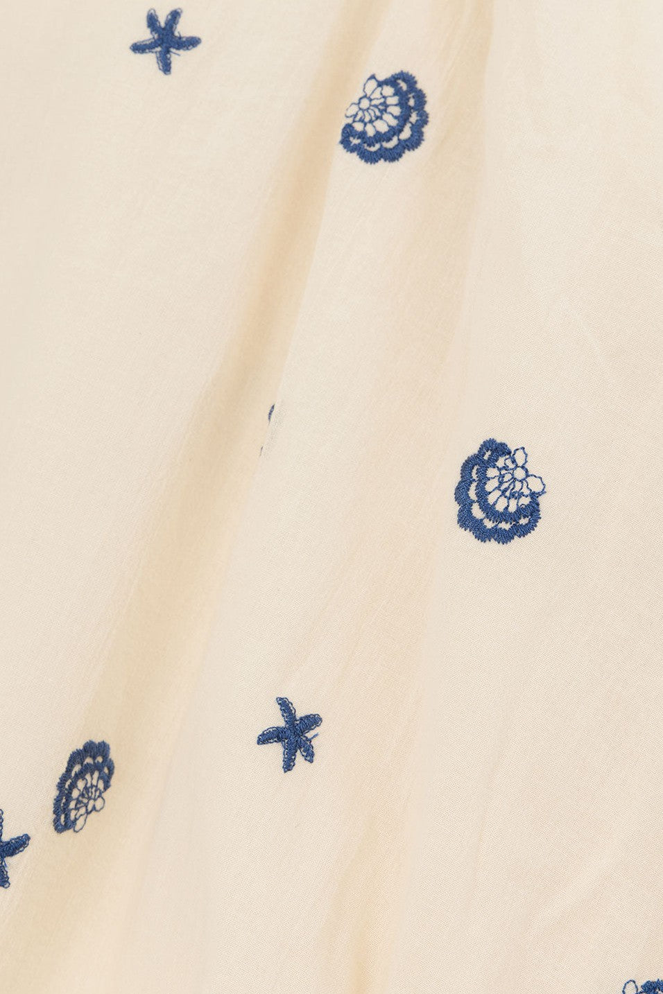 Cream mini dress with shirred detailing, side view