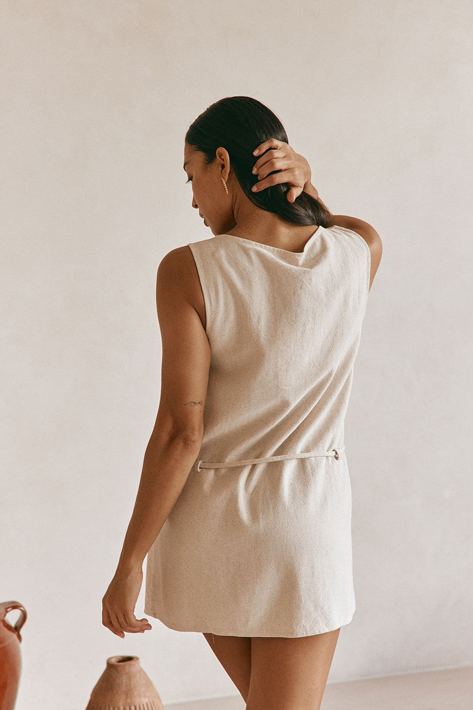 Beige mini dress with an A-line skirt, detail view