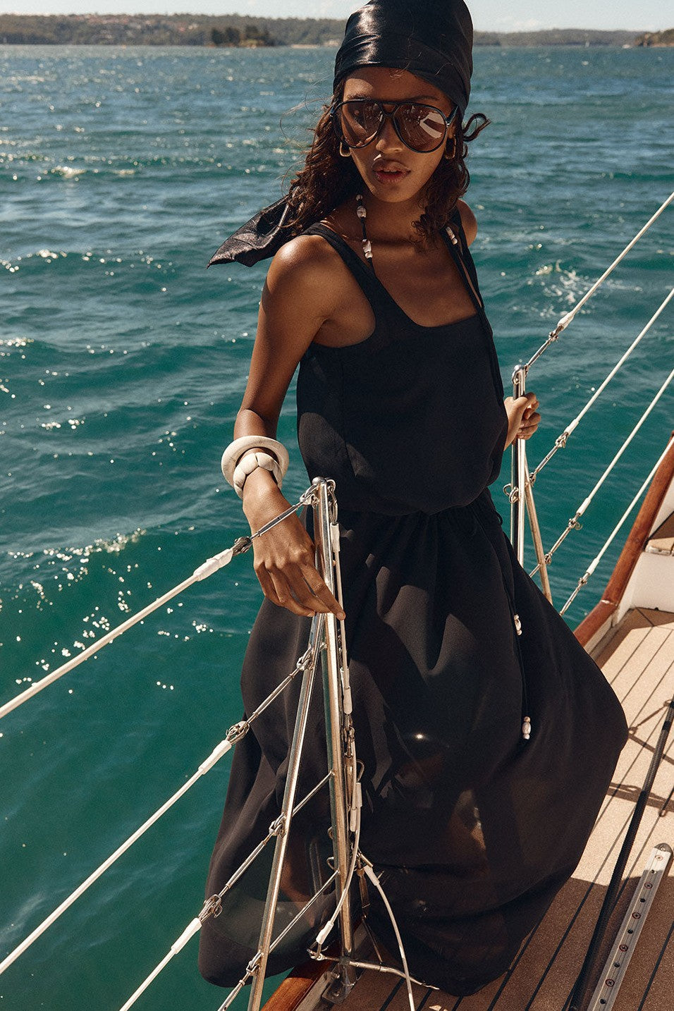 Black maxi dress with a halter neckline, styled on model
