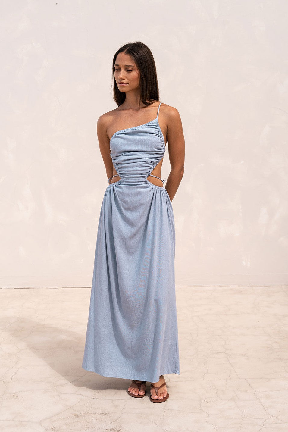 Blue maxi dress with an open back, styled on model