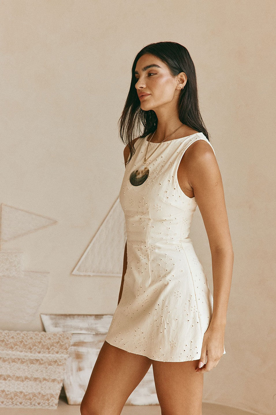 Cream mini dress with an A-line skirt, styled on model