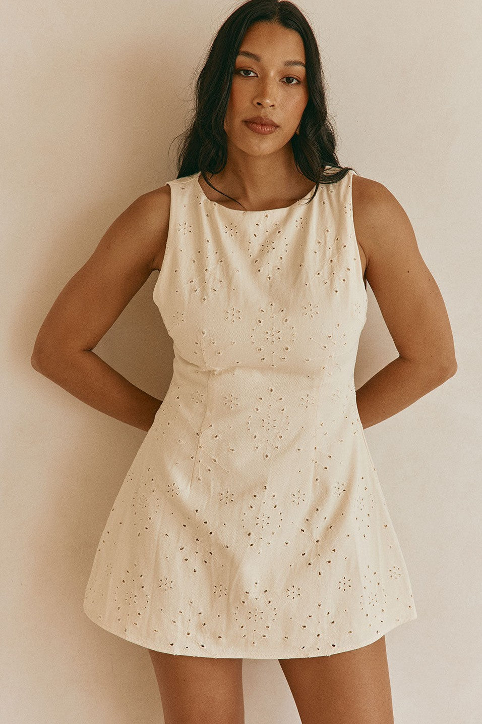 Cream mini dress with an A-line skirt, back view