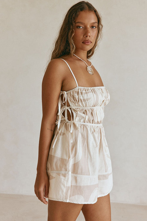 Beige mini dress with a side split, back view