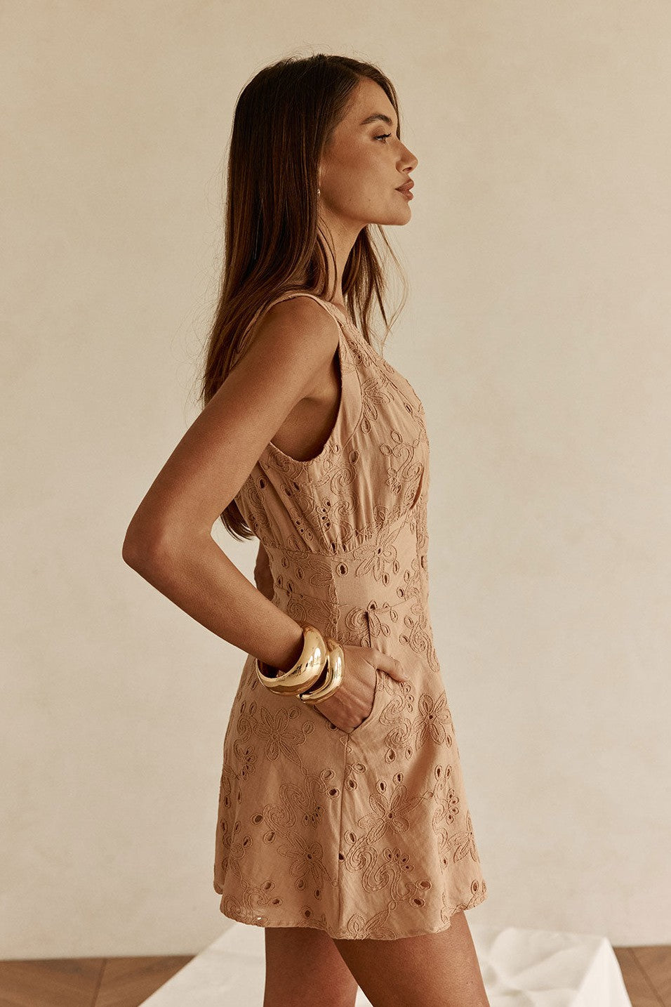 Cream mini dress with a plunging V neckline, detail view