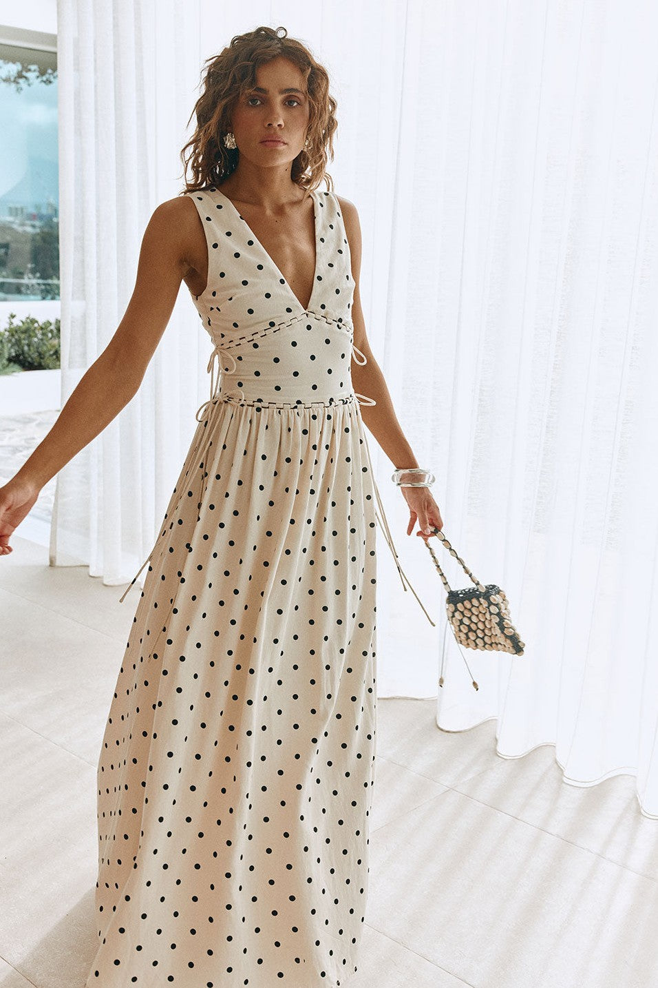 Cream maxi dress with a plunging V neckline, detail view