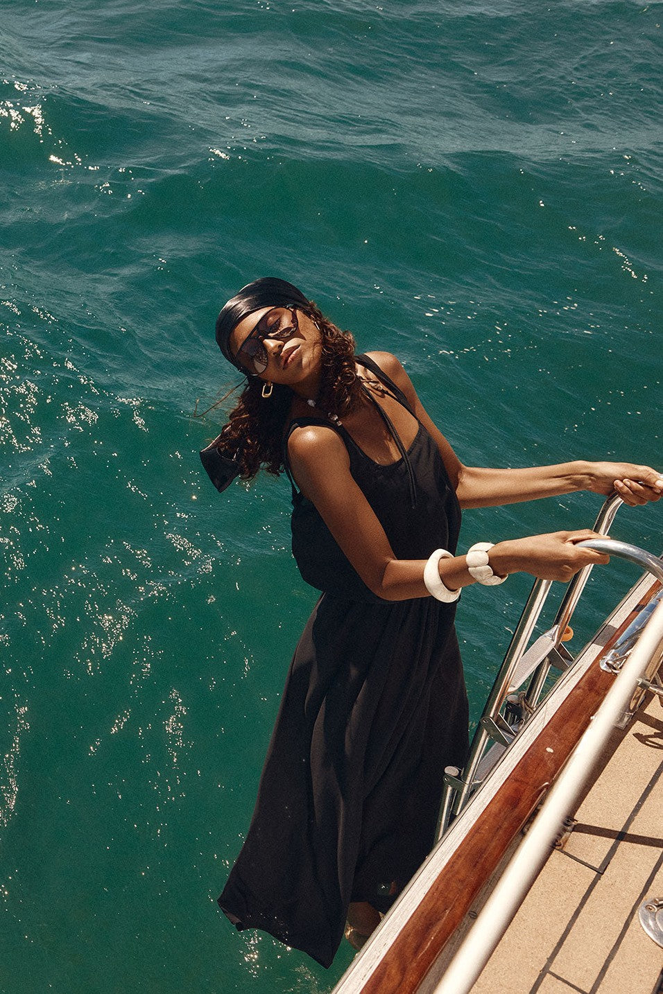 Black maxi dress with a halter neckline, side view