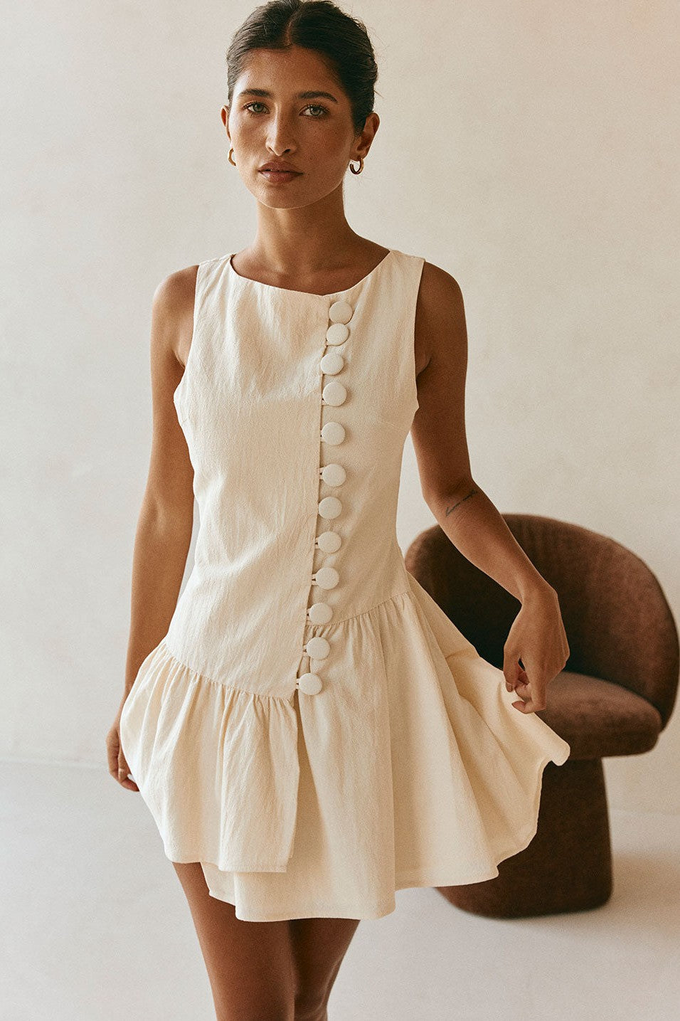Cream mini dress with a boat neckline, side view