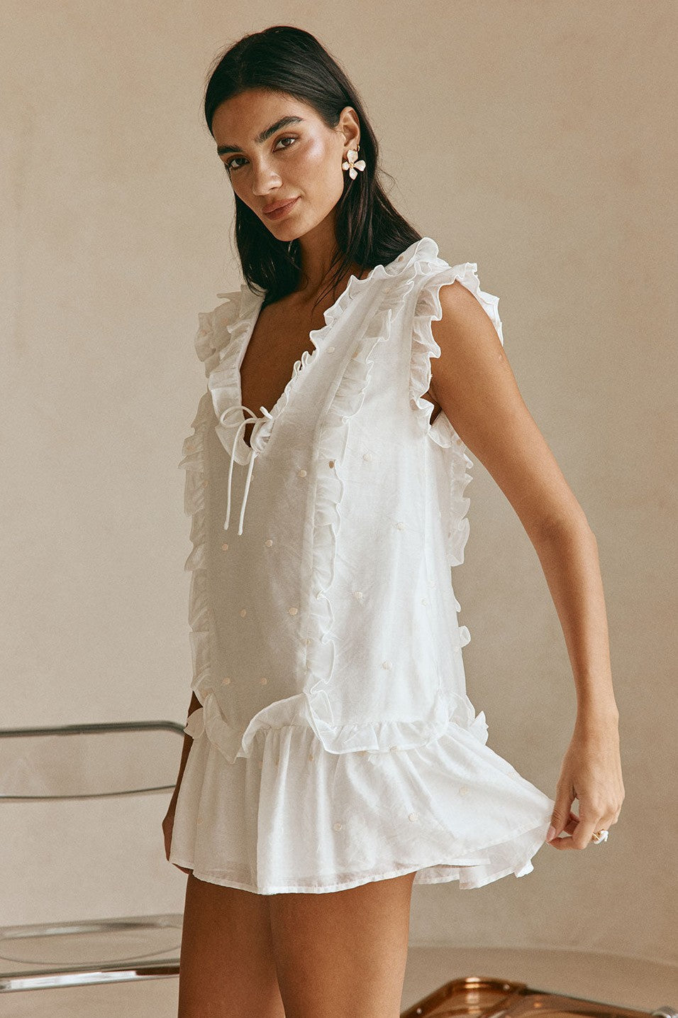 White mini dress with a V neckline, detail view