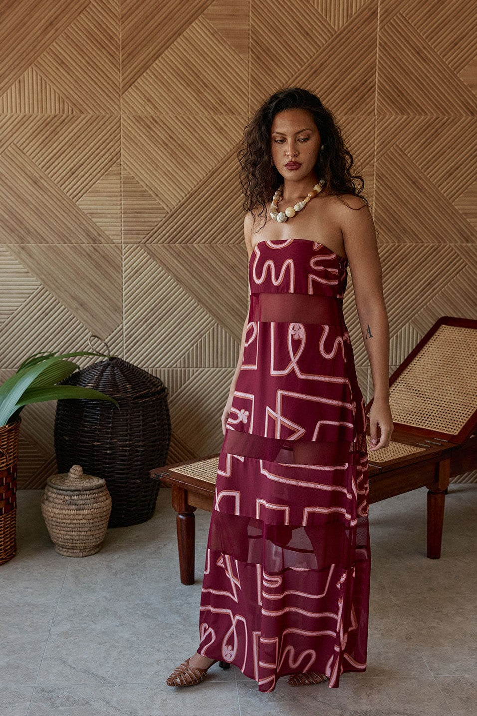 Pink maxi dress with a strapless neckline, styled on model