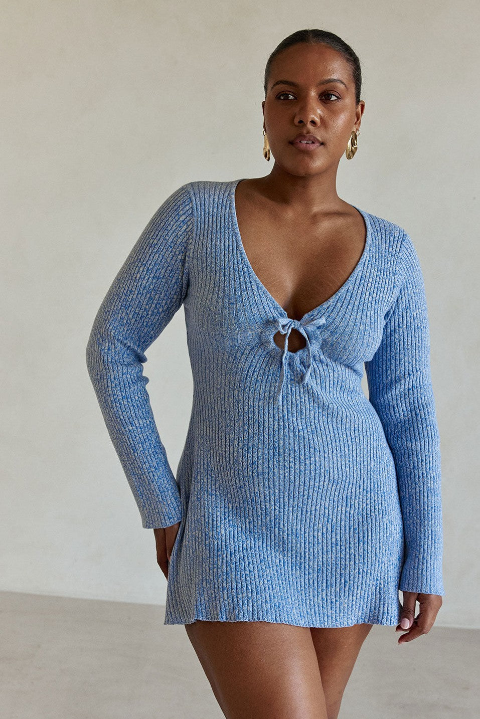 Blue mini dress with a plunging V neckline, side view