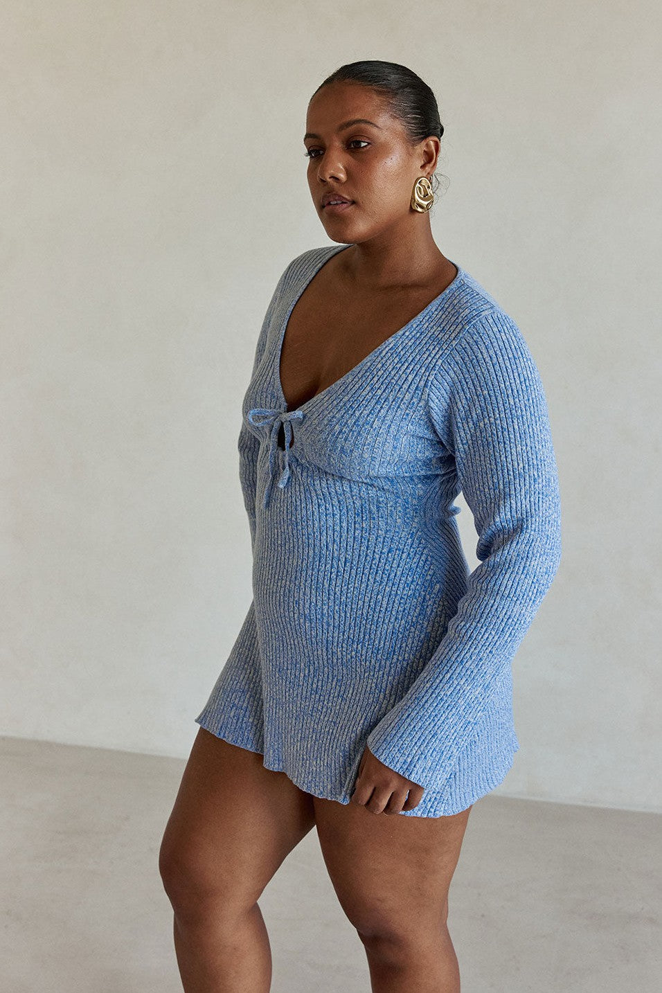 Blue mini dress with a plunging V neckline, back view