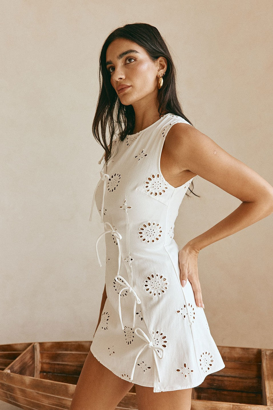 White mini dress with an A-line skirt, styled on model