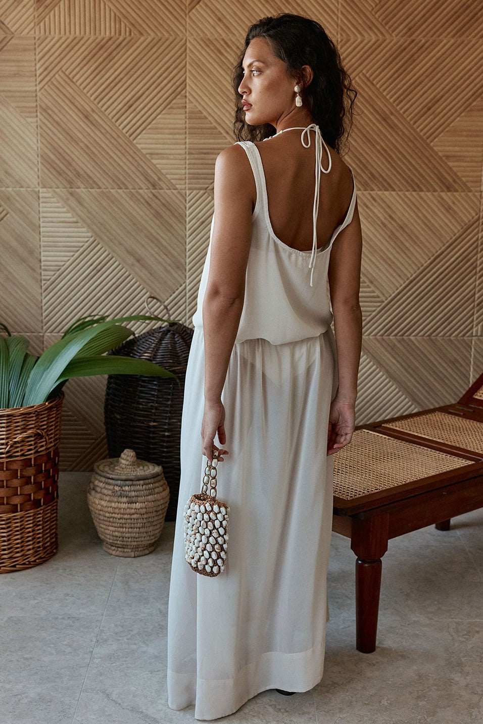 Beige maxi dress with a halter neckline, styled on model